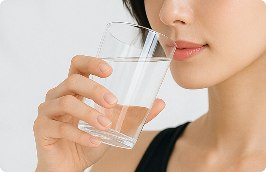 グラスの水を飲む女性の写真